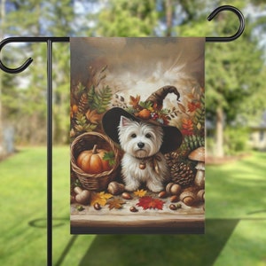 May include: A white dog wearing a witch's hat with fall foliage and a pumpkin in a basket. The dog is surrounded by fall leaves, acorns, and pine cones.