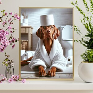 May include: A brown and white dog wearing a white bathrobe and a toilet paper roll hat is sitting in a bathroom. The dog is surrounded by toilet paper rolls.