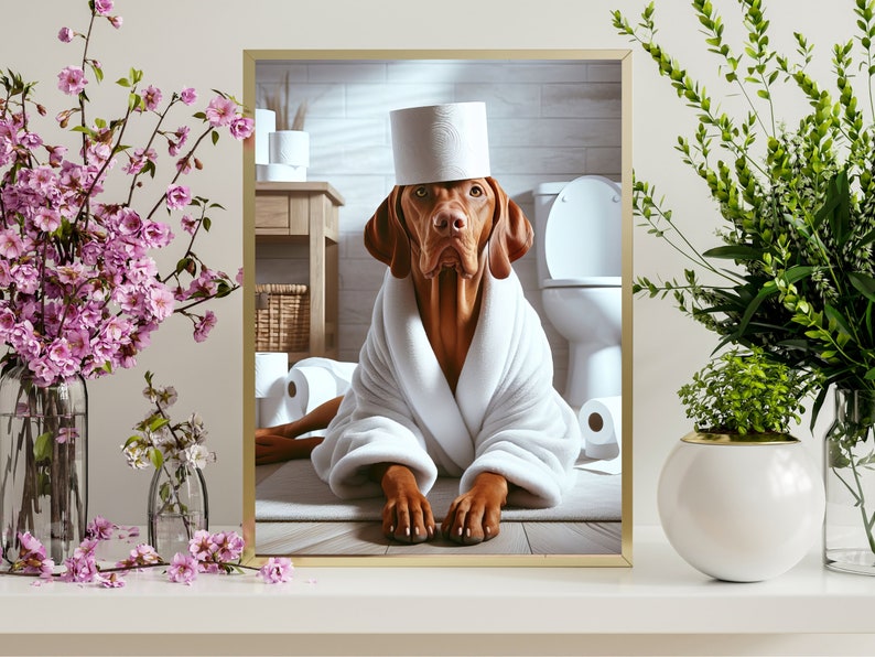 May include: A brown and white dog wearing a white bathrobe and a toilet paper roll hat is sitting in a bathroom. The dog is surrounded by toilet paper rolls.