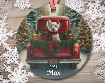 May include: Round Christmas ornament featuring a white dog in a red truck bed, wearing a Santa hat and plaid scarf. The truck is decorated with greenery and a red bow. The ornament has the text "2024 Max".