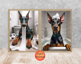 May include: Two framed prints featuring Doberman Pinschers. One shows a dog in a bathroom with toilet paper, the other shows a dog in a bathtub with bubbles on its head. The prints have a light wood frame.