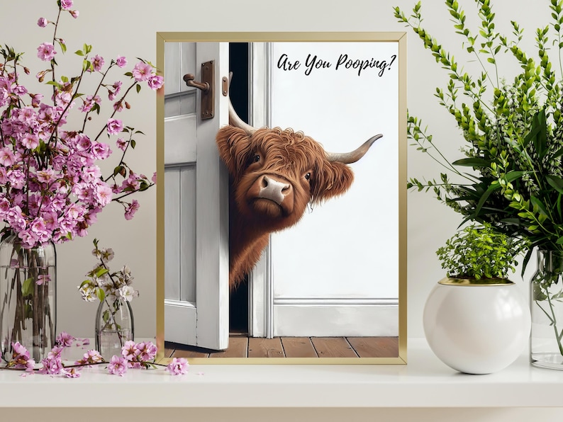 May include: A brown and white Highland cow peeks through a white door with the text "Are You Pooing?" printed above the cow.