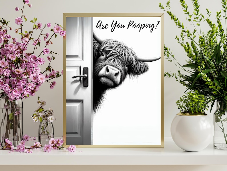 May include: A black and white illustration of a Highland cow peeking around a door with the text "Are You Pooping?" printed above the cow.