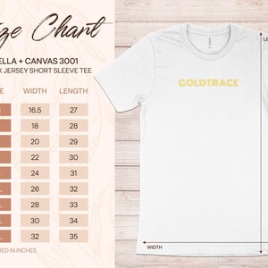 Op de afbeelding: Maattabel voor een unisex T-shirt met korte mouwen met de tekst "GOLDTRACE" bedrukt op de voorkant. De tabel toont de breedte- en lengtematen in inches voor maten XS tot 5XL.