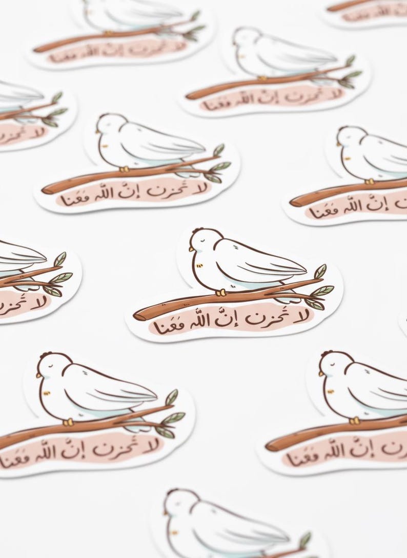 May include: White dove stickers perched on brown branches, each with Arabic text. The stickers have a light pink background and a white border. The image is a close-up shot of multiple stickers.
