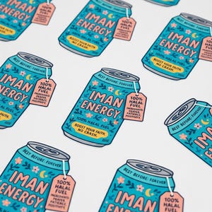 May include: A collection of teal-colored can stickers with the words "IMAN ENERGY" in pink, adorned with floral and crescent moon designs. Each sticker includes a tag that reads "100% HALAL FUEL" and the phrase "BOOST YOUR FAITH, NO CRASH."