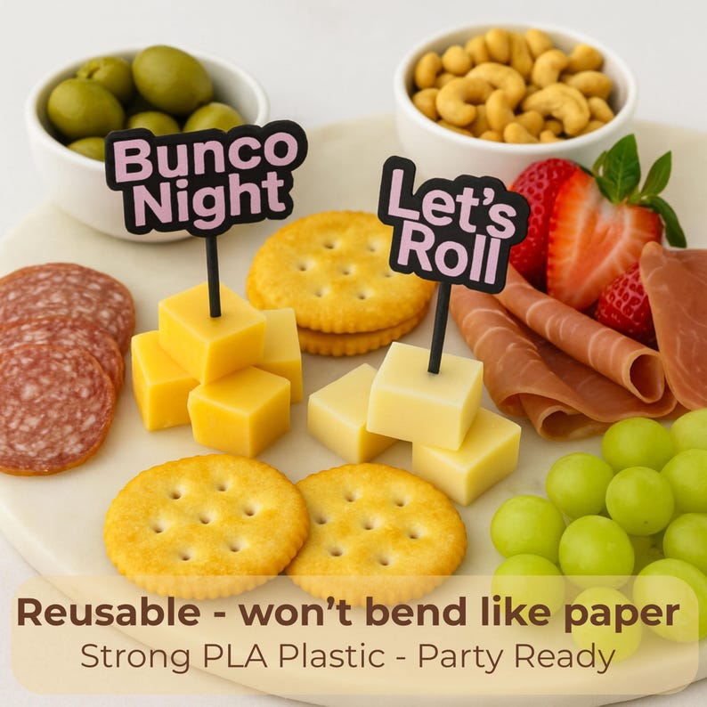 May include: A party platter with crackers, cheese cubes, salami, olives, cashews, grapes, strawberries, and prosciutto. Black signs read "Bunco Night" and "Let's Roll". The text on the image says "Reusable - won't bend like paper" and "Strong PLA Plastic - Party Ready".