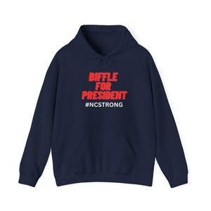 May include: Navy blue hoodie with a red graphic that says "Biffle for President" and "#NCSTRONG" in white.