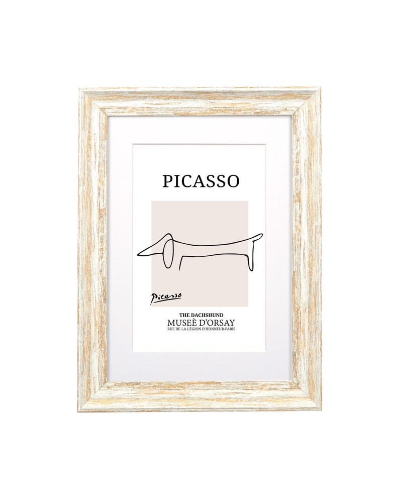 May include: A white wood picture frame with a white mount and a black and white line drawing of a dachshund. The drawing is titled "PICASSO" and the text "THE DACHSHUND MUSEE D'ORSAY RUE DE LA LEGION D'HONNEUR-PARIS" is below the drawing.