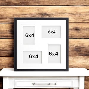 May include: Black picture frame with four 6x4 inch openings. The frame is on a white surface.
