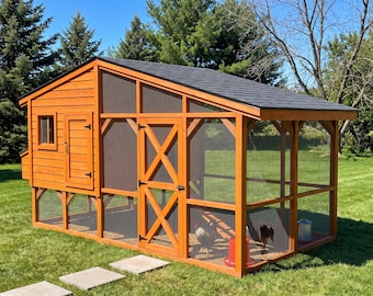 May include: A wooden chicken coop with a dark shingled roof, featuring a solid enclosed nesting area on the left and a large wire mesh run on the right. The structure includes a hinged door with an X-brace, a small window, and two chickens inside.