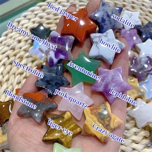 May include: A collection of 12 star-shaped polished stones, each with a different color and pattern. The stones include red jasper, sodalite, howlite, dreamy amethyst, aventurine, lepidolite, spectrolite, pink quartz, crazy agate, bloodstone, tiger-eye.