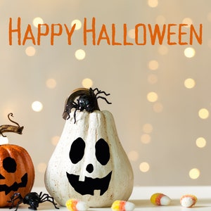 May include: Two Halloween pumpkins with painted faces, one orange and one white, with black spiders on top. The pumpkins are on a table with candy corn scattered around them. The text "Happy Halloween" is written in orange above the pumpkins.