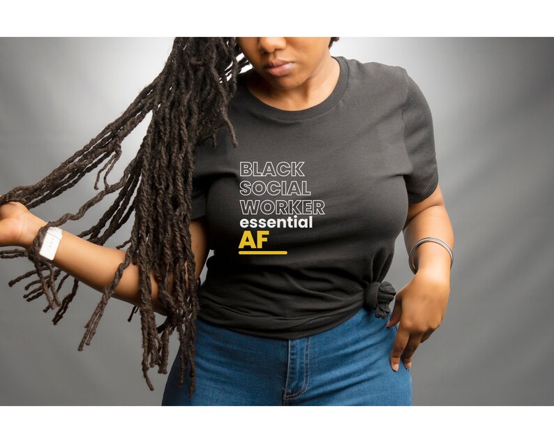 May include: A black t-shirt with the text "Black Social Worker essential AF" in white and yellow lettering.