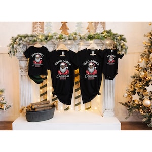 May include: A set of four black t-shirts featuring a graphic of a Black Santa Claus. The shirts have the text "Smith Family Christmas 2024" printed on them.