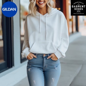 May include: A white hooded sweatshirt with a kangaroo pocket and a drawstring hood. The sweatshirt is worn by a person with light blue jeans.