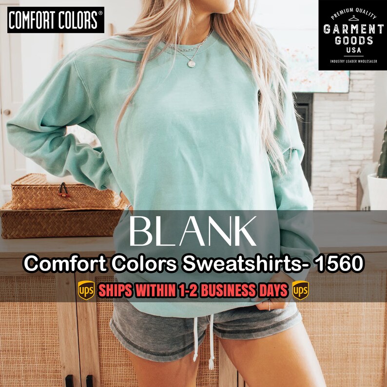 Puede incluir: Una sudadera de color azul claro con el texto "BLANK" y "Comfort Colors Sweatshirts - 1560" impreso en ella. El texto "SHIPS WITHIN 1-2 BUSINESS DAYS" tambi&eacute;n est&aacute; impreso en la imagen.