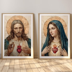 May include: Two framed religious portraits. One depicts a man with long brown hair, a beard, and a halo, wearing a white shirt with a red heart emblem. The other shows a woman with a blue veil and a halo, wearing a white shirt with a heart emblem.
