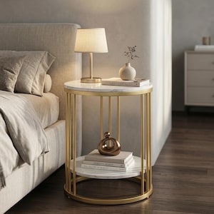 May include: A round side table with a white marble top and a gold metal frame. A small lamp with a beige shade sits on top, along with a vase and books. The lower shelf holds books and a decorative object. The table is next to a bed.