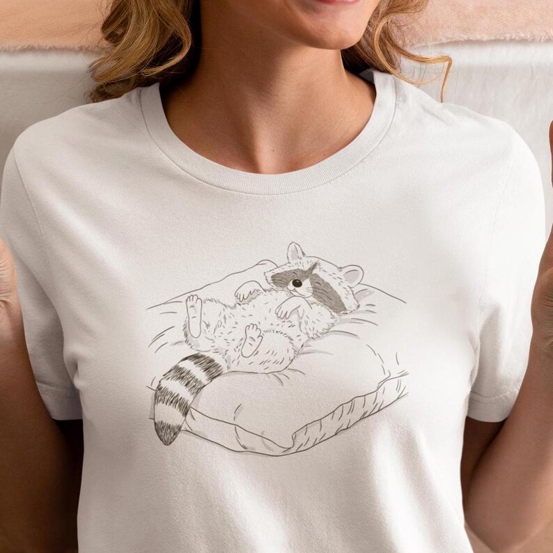 Schlurpi the Raccoon T-Shirt – Cozy Nap | Women’s Organic Cotton Shirt | Sketch-Style Raccoon Illustration