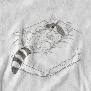 Schlurpi the Raccoon T-Shirt – Cozy Nap | Women’s Organic Cotton Shirt | Sketch-Style Raccoon Illustration