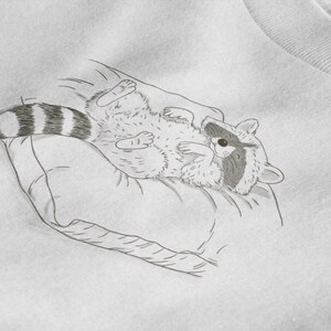 Schlurpi the Raccoon T-Shirt – Cozy Nap | Women’s Organic Cotton Shirt | Sketch-Style Raccoon Illustration