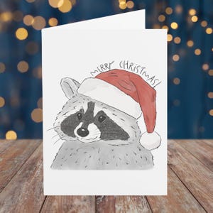 Carte de Noël raton laveur, carte de voeux Père Noël Schlurpi - carte exclusive illustrée à la main à l'aquarelle et au crayon pour les amateurs de raton laveur, papier mat