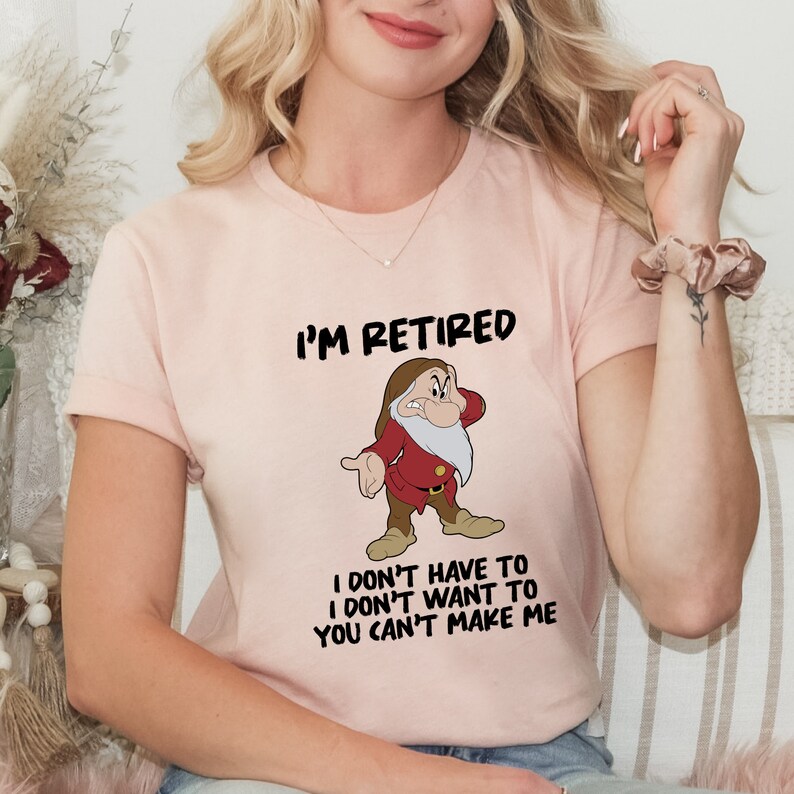 May include: A pink t-shirt with a cartoon image of a grumpy dwarf and the text "I'm Retired I don't have to I don't want to You can't make me".