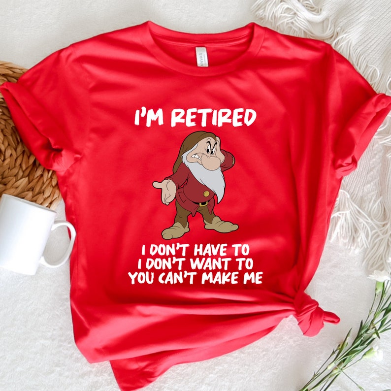 May include: Red t-shirt with a white graphic of a cartoon dwarf with a beard and the text "I'm Retired I don't have to I don't want to You can't make me".