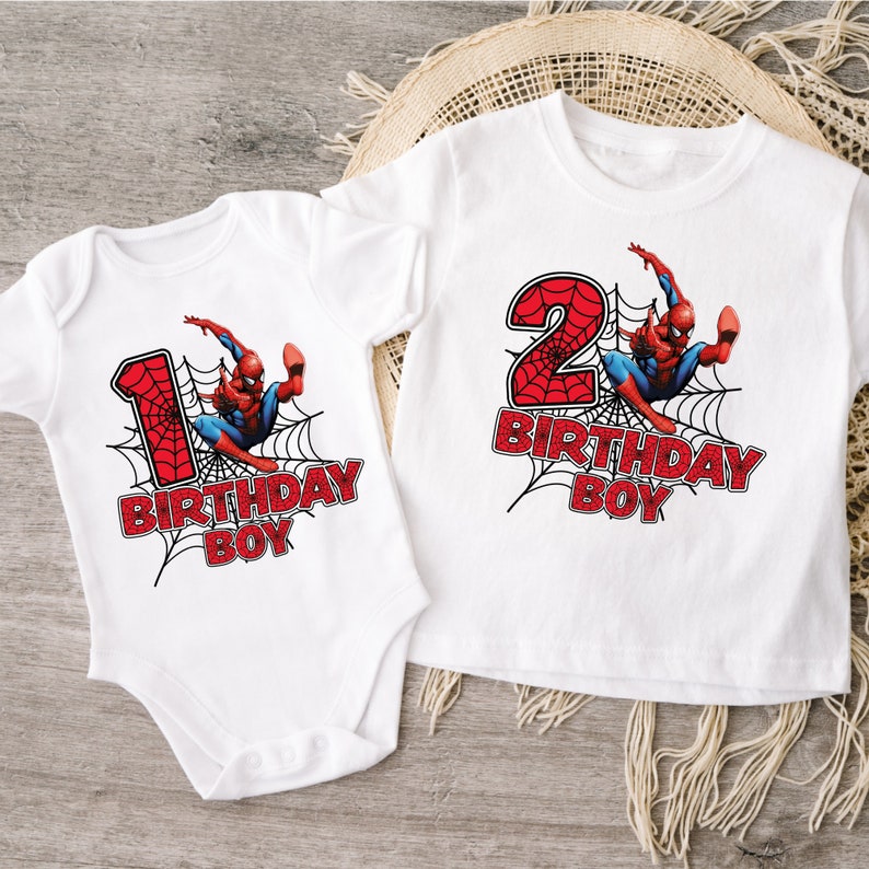 May include: Two white t-shirts with a Spiderman graphic and the text "Birthday Boy". One shirt has the number "1" and the other has the number "2".