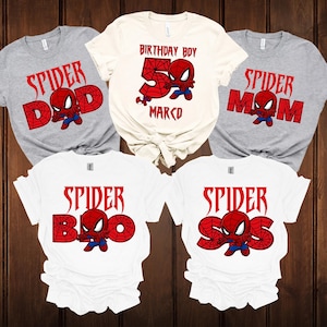 May include: Five t-shirts with a Spider-Man theme. The shirts are grey and white, with red text and a Spider-Man graphic. The text includes "Spider Dad", "Spider Mom", "Spider Bro", "Spider Sis", and "Birthday Boy 5 Marco".