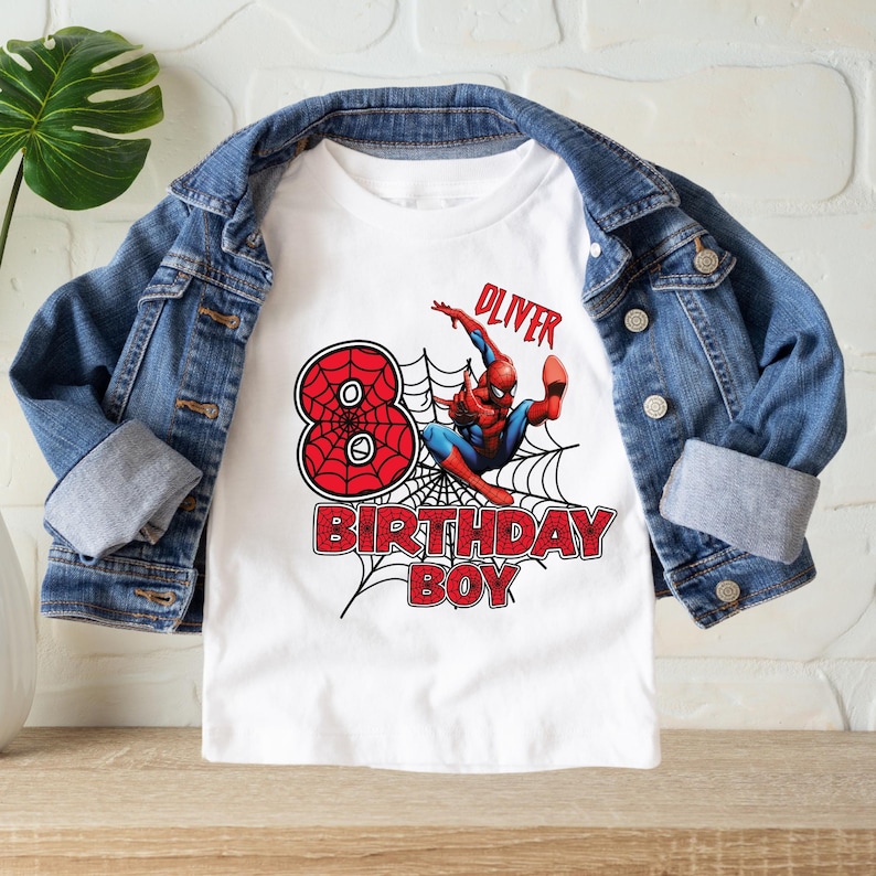 May include: White t-shirt with a red number 8, a Spiderman graphic, and the text "Oliver Birthday Boy".