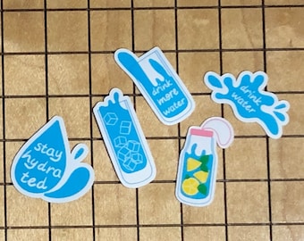 May include: Five blue and white water-themed stickers with motivational messages. The stickers feature a glass of ice water, a bottle of lemonade, a water droplet, and two splashes of water with the text "drink more water" and "drink water".