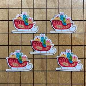 May include: Four red and white Christmas sleighs with colorful presents and a festive design. Each sleigh is decorated with leaves and a white background.