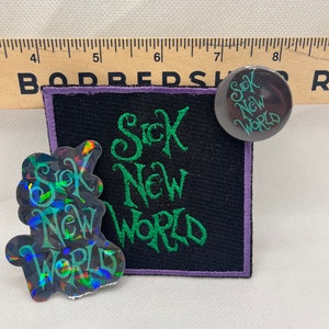 May include: A black fabric patch with green embroidered text that reads "Sick New World". There is also a smaller black button with the same text in green. A holographic sticker with the same text in green is also included.
