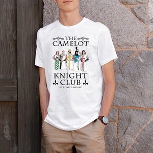 May include: White t-shirt with a graphic of knights from the movie Monty Python and the Holy Grail. The graphic says "The Camelot Knight Club (It's only a model)"
