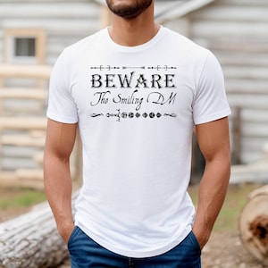 Beware The Smiling DM- DND TShirt- Black Font | Dungeon Master TShirt | Fun Gamer Tee | Favorite D&D TShirt | Dungeons and Dragons TShirt