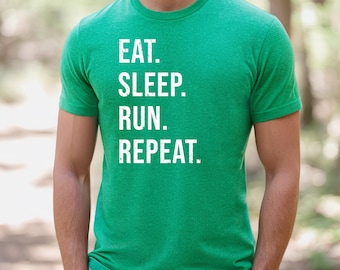 May include: A green t-shirt with the text "EAT. SLEEP. RUN. REPEAT." in white.