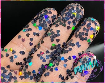 May include: Black heart-shaped glitter with iridescent rainbow accents.