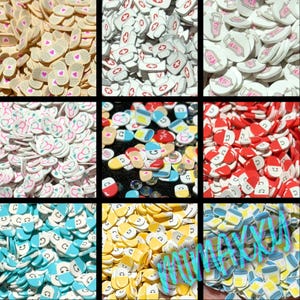 May include: A collection of polymer clay slices in various designs, including bandages with hearts, medical crosses, stethoscopes, medicine bottles, pills, and smiling faces. The colors include white, red, blue, yellow, and tan.