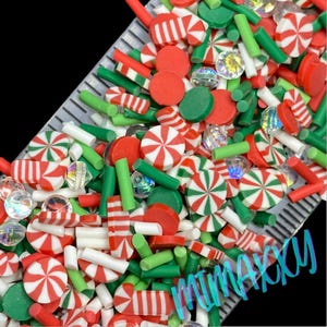 May include: A variety of red, white, and green candy cane sprinkles, red and green round sprinkles, and clear iridescent rhinestones.