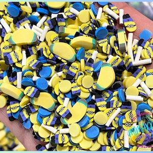 May include: A variety of colorful resin charms featuring a Minion theme. The charms include yellow banana slices, blue and yellow circles, and small Minion figures with goggles and overalls.