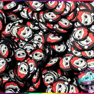 May include: A large pile of black and red round Christmas ornaments with a white Jack Skellington face wearing a Santa hat. The ornaments are made of polymer clay and are perfect for adding a spooky touch to your Christmas decor.
