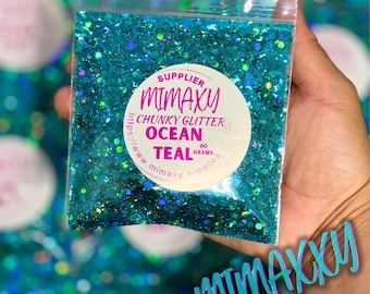 Può includere: Primo piano di glitter chunky color teal in un sacchetto di plastica trasparente. Il sacchetto ha un'etichetta bianca con il testo "SUPPLIER MIMAXY CHUNKY GLITTER OCEAN TEAL 60 GRAMS https://www.mimaxysupplies.com".