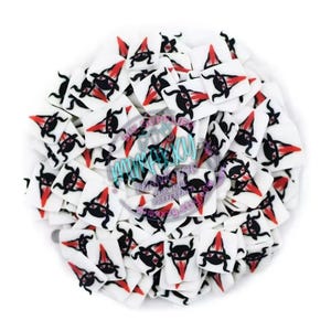 May include: A pile of white square-shaped polymer clay charms with a black and red witch design. The charms are perfect for adding a spooky touch to crafts and projects.