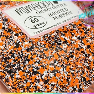 May include: Orange, black, and white chunky glitter with a Halloween theme. The glitter is labeled "Haunted Pumpkin" and weighs 60 grams.