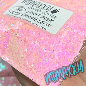 May include: A close-up of a bag of light pink chunky glitter with a holographic finish. The bag is labeled "Mimaxxu Chunky Glitter Light Pink Chameleon" and "60 grams".