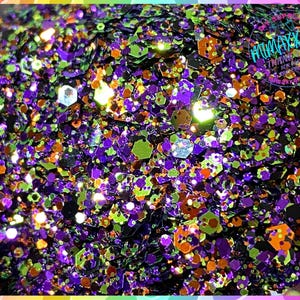 May include: A close-up of a mix of purple, green, orange, and gold glitter. The glitter is a mix of different shapes and sizes.