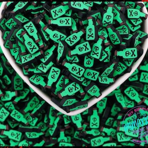 May include: A bowl filled with green and black poison bottle charms. The charms are made of resin and have a skull and crossbones design. The charms are perfect for adding a spooky touch to your crafts.
