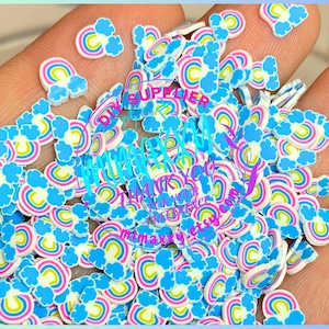May include: A large pile of colorful rainbow and cloud shaped resin flatback embellishments. These are perfect for adding a whimsical touch to crafts, jewelry, and more.